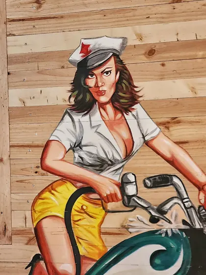 A detailed shot of the painted figure, capturing the classic American diner art style.