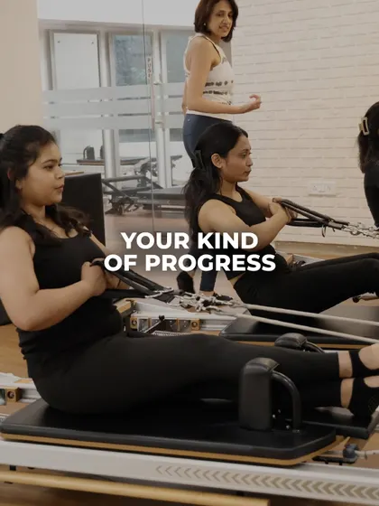 A group of women engaged in a seated rowing series on the reformer, building upper back strength and improving posture together.