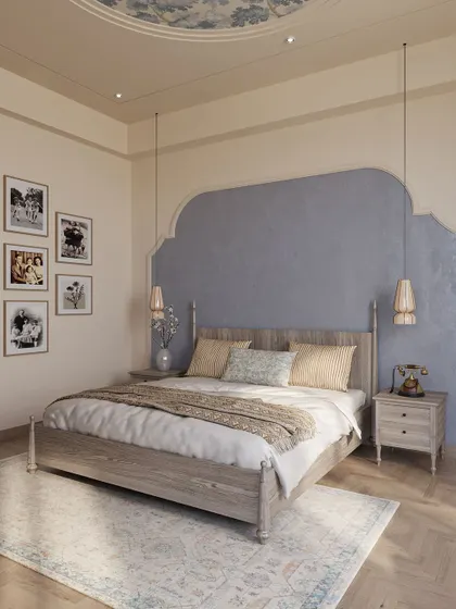 This bedroom design evokes a sense of nostalgia and classical charm. A textured blue accent wall creates a focal point behind the traditional wooden bed, while a gallery wall of family photos makes the space deeply personal.