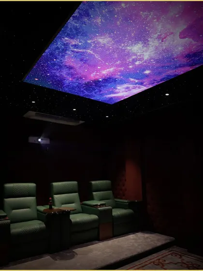 Another angle of our custom home theater, highlighting the dramatic effect of the fiber optic and printed galaxy ceiling. This feature adds a unique visual dimension, making movie nights truly magical.