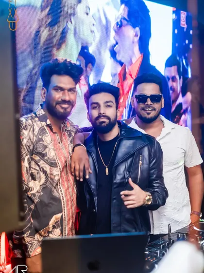 Taking a moment for a photo with the crew behind the DJ booth. It takes a team to put on a great night.