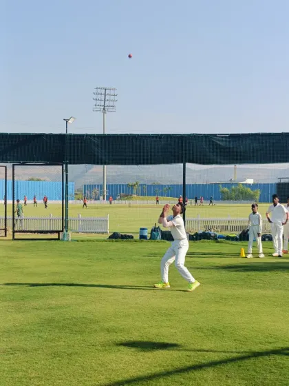 Another successful high catch during our fielding practice. The player's form and concentration highlight the effectiveness of our coaching methods.