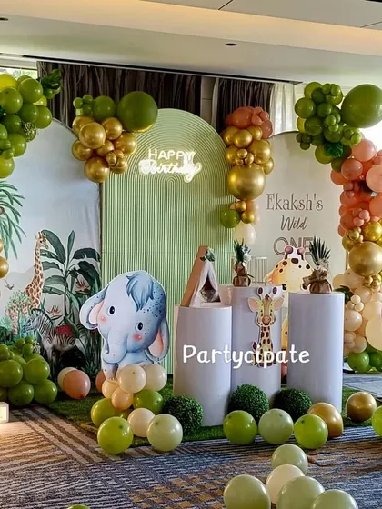 Another angle of Ekaksh's safari setup, highlighting the balloon arrangements and the cute elephant cutout. The use of different shades of green and gold gives it a rich, jungle feel.