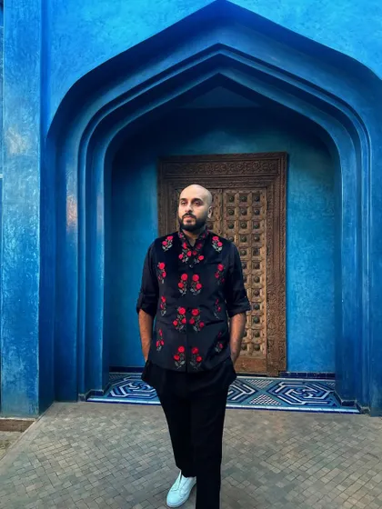 A closer look at my floral embroidered vest against the Moroccan blue. My outfits are always chosen to complement the event's theme and location.