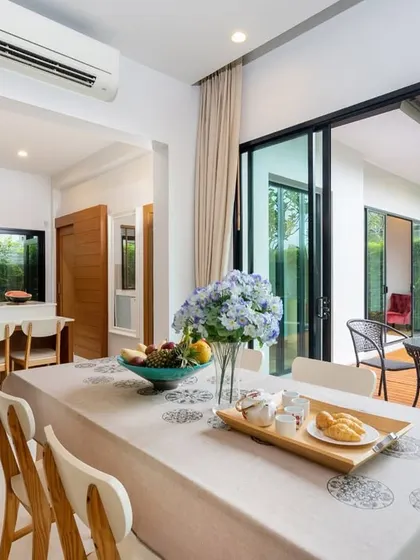This stunning open-concept dining area seamlessly extends to an outdoor patio and pool, creating the perfect blend of indoor comfort and outdoor serenity for luxurious living.