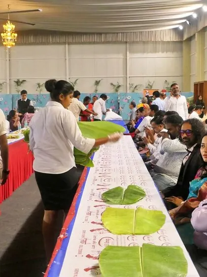 My staff laying out fresh banana leaves just before the guests are seated. This ensures maximum freshness and hygiene for the traditional ela sadya.