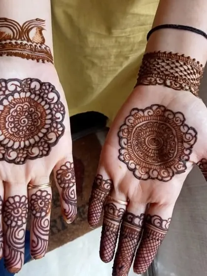 A beautiful and neat mandala design for Karwa Chauth, with two different styles on each hand.
