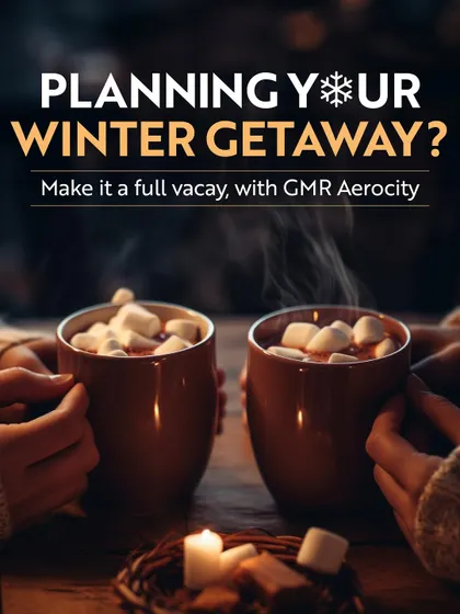 Planning your winter getaway? This image of two people enjoying hot chocolate by candlelight invites you to make it a full vacation with a cozy and festive stay at Aerocity.