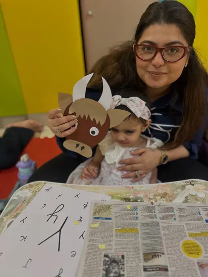 This mother and child pair show off their completed yak craft, a fun outcome of our themed learning sessions.
