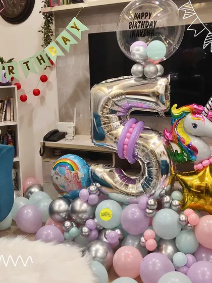 A magical unicorn-themed bouquet for a 5th birthday. The large silver number '5' balloon is paired with a unicorn foil balloon and a cascade of pastel and silver balloons.