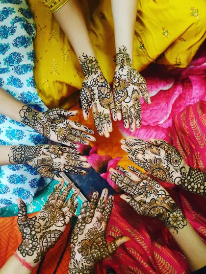 A fun shot of a group of friends showing off their unique mehendi designs. I love creating a different pattern for each person.