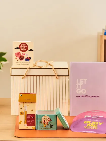 A beautifully arranged "Zen Gift Box" to encourage a moment of peace, featuring a journal and other soothing self-care products.