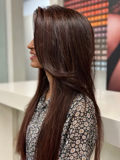A beautiful cherry brown hair color. This shade is the perfect blend of rich brown with a hint of red, giving the hair a warm, vibrant glow that catches the light beautifully.