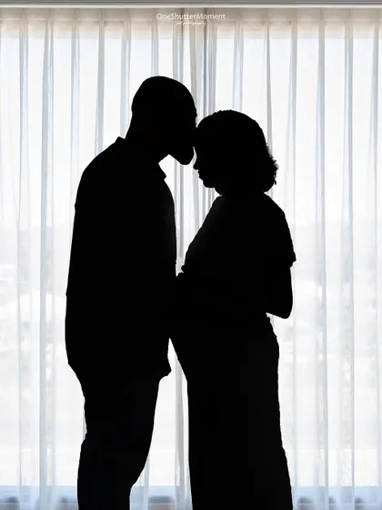 Sometimes, a silhouette says it all. This artistic shot captures the intimate connection between a couple as they look forward to becoming parents. It's a timeless and emotional way to remember this special time.