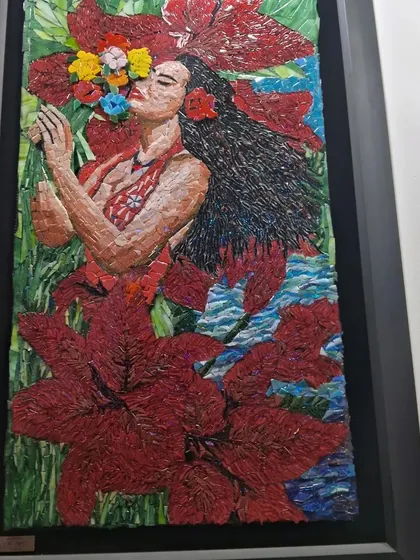 A mosaic of a woman in a red floral setting by Nagla, showcasing her vibrant and detailed work.