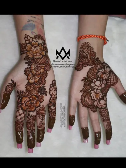 A stylish and modern take on Arabic mehendi, with asymmetrical designs on each hand.