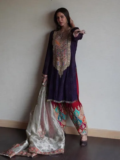 This pose shows the elegant flow of the dupatta and the detailed craftsmanship of the entire ensemble. It's a perfect look for anyone wanting to embrace traditional Punjabi style with a high-fashion sensibility.