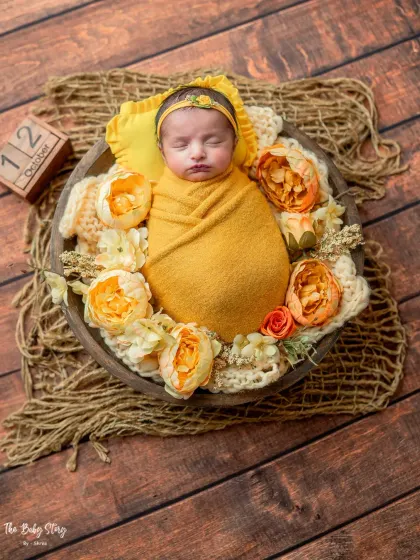 This wider shot of the yellow bowl setup includes a date block, a great way to commemorate your baby's birth date in the photos.