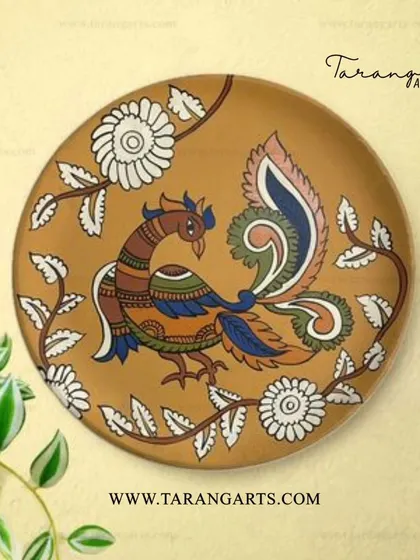A beautiful wooden wall hanging featuring a peacock painted in the traditional Kalamkari style. The intricate lines and earthy colors are hallmarks of this ancient art form, bringing a piece of heritage to your walls.