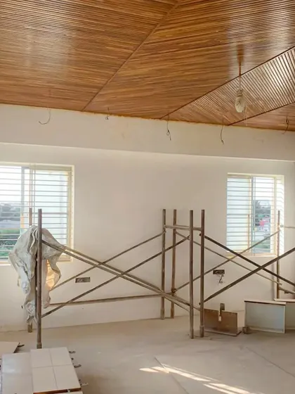 Another view of the wooden ceiling installation, showcasing the craftsmanship and the warm, luxurious feel it brings to the space.