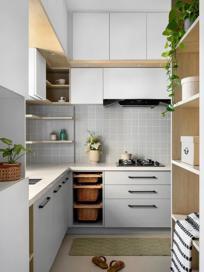 This 'Mellow Menlo' kitchen is soothing and cottagish, with a monochrome palette of soft greys and whites. We extended the space from the foyer to create a compact yet highly functional layout with plenty of storage.