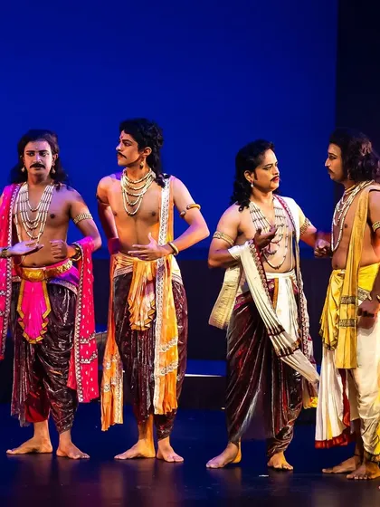 A pivotal scene from 'Krishnaa', depicting the interaction between Lord Krishna and the Pandavas. The choreography here focuses on character interaction and narrative progression, using classical dance to tell a complex story.