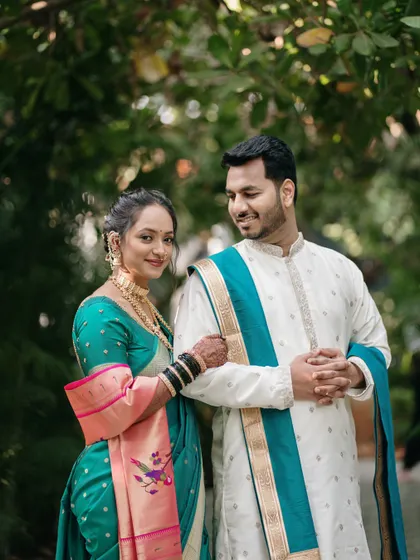 The elegance of a Paithani saree and a classic kurta, captured in a quiet moment of connection in a lush garden setting.