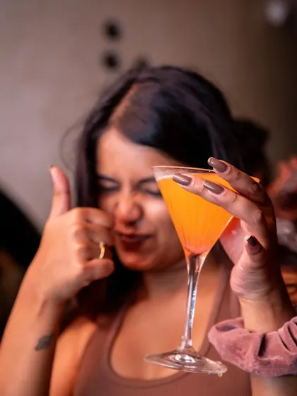 A thumbs up for the cocktails and the vibe. A guest giving her seal of approval for the JU:CY experience at Lumara.