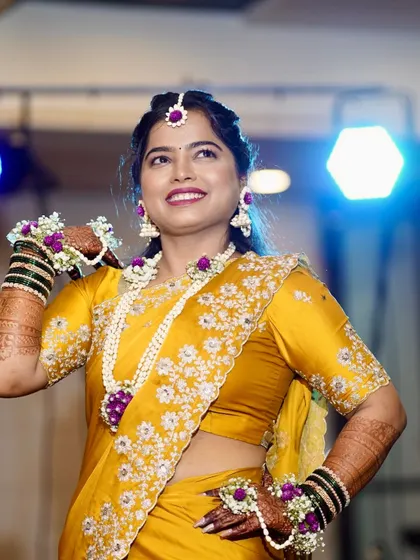 A vibrant Haldi look requires a hairstyle that is both beautiful and practical. I created a lovely half-up style that keeps the hair off the face while perfectly complementing the traditional floral jewelry worn for the ceremony.