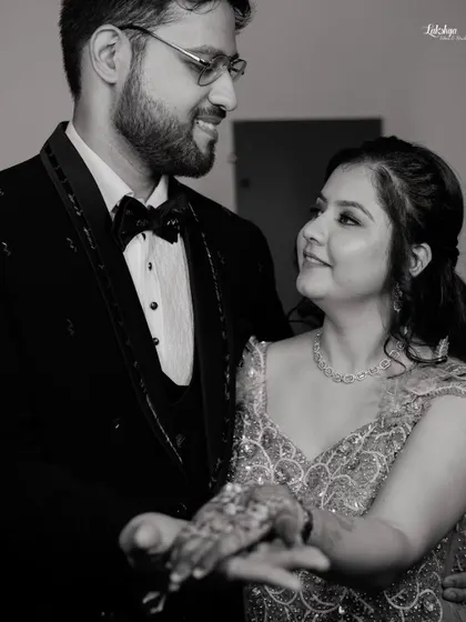 A classic black and white photo of the couple sharing a dance. This timeless style emphasizes their expressions and the romance of the moment.