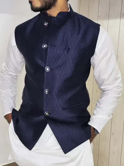A close-up of the navy blue jacquard jacket, showing the texture of the fabric.