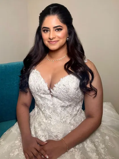 The full look is one of modern elegance. The simple yet flawless makeup pairs perfectly with her beautiful lace wedding dress.