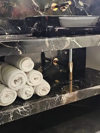 Don't forget to deck up your powder room for guests. The simplest way to elevate the space is by using a spa-style folding technique for your hand towels.