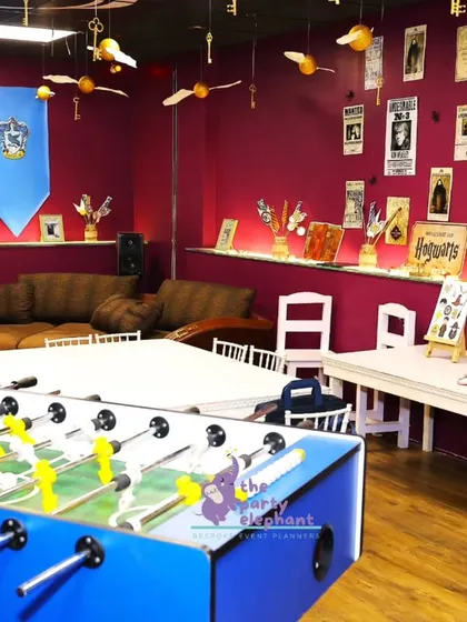 The party space included banners for the different Hogwarts houses, like Slytherin and Ravenclaw, making every guest feel like they were part of the school. I also included games like foosball for extra fun.