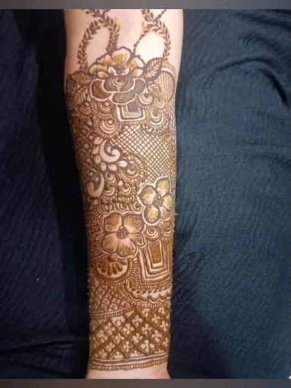 A lovely bridal arm piece featuring a basket of flowers motif. This is a unique element that can be incorporated into a traditional design.