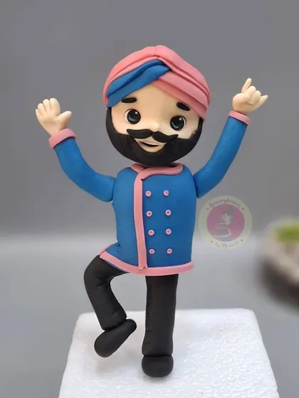 A fun, dancing figurine of Chef Harpal Singh Sokhi, also created for the "Laughter Chefs" cake.
