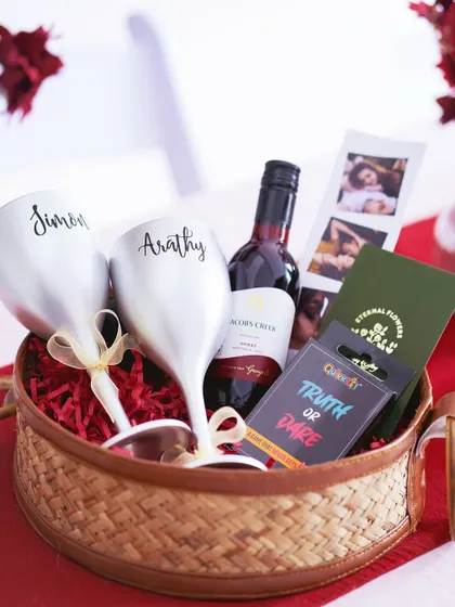 A side view of the 'Romantic Escape' hamper, showing the depth of the basket and the careful arrangement of items.