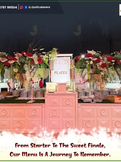A beautifully designed plate station with a soft pink, textured counter and large floral bouquets, ensuring even the practical elements of the event are stylish.