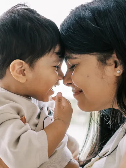 A close-up of a mother and son, nose to nose. An incredibly sweet and intimate moment.