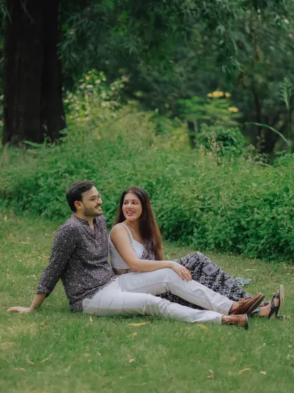 A relaxed moment for Jayashree and Anand, sitting together on the grass. This photo captures the easy comfort and happiness of their relationship.