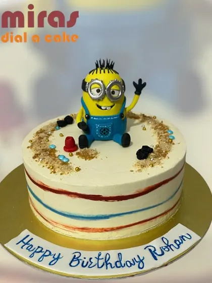 A playful Minion cake perfect for a birthday celebration. This design features a sculpted Minion sitting on top, ready to cause some happy mischief.