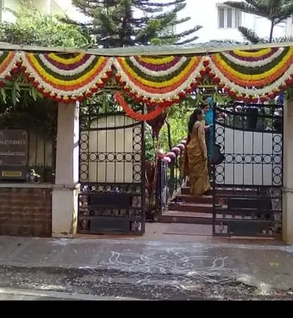 A simple chapra frame decorated with colorful flower garlands. This is a great way to create a traditional entrance for any auspicious occasion.