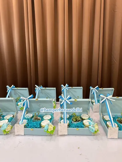 A wide shot of the bulk corporate hamper order for Raffles Hotel. We ensure every single hamper in a large order is consistent in quality and presentation, right down to the bow on top.