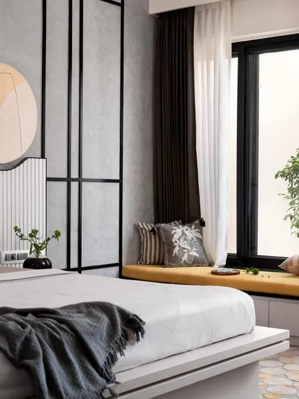 This angle shows the full layout of the master bedroom, including the cozy bay window seating with a pop of yellow, which contrasts beautifully with the monochrome and wood tones of the room.