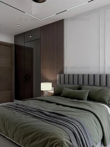 Another view of the guest bedroom, highlighting the vertical-paneled headboard and modern gold-accented wall lamps.