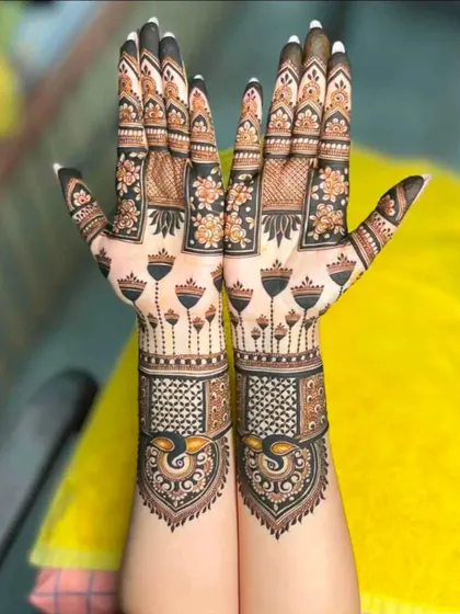 A unique and modern design with peacock motifs at the wrist and a pattern of rising tulips on the back of the hands.