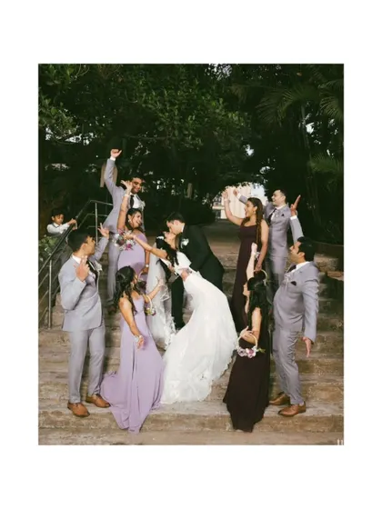 A fun, energetic shot of the wedding party celebrating on the steps. This image is full of life and personality, capturing the joy of the day.