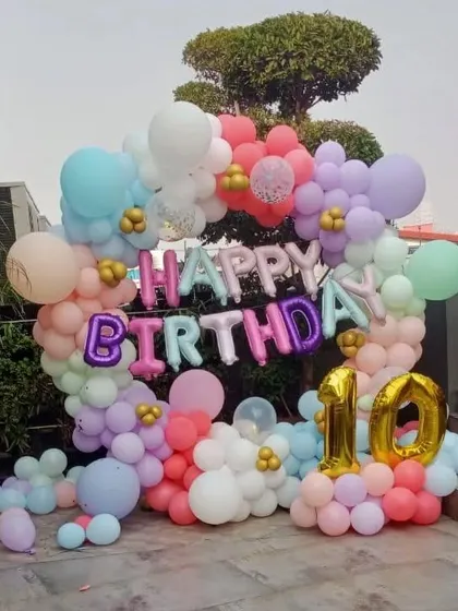 A beautiful outdoor balloon ring for a 10th birthday celebration at home. The pastel colors look wonderful in natural daylight.
