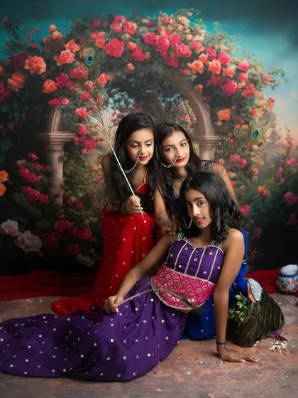 A dramatic pose from our modern Radha shoot. The rich colors and floral arch backdrop create a stunning, painterly effect.