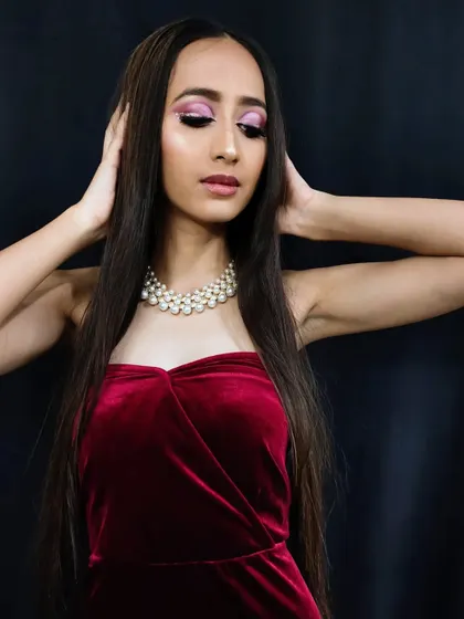 A glamorous look featuring a vibrant pink cut-crease and a velvet dress. This is a great example of a bold, modern party look.